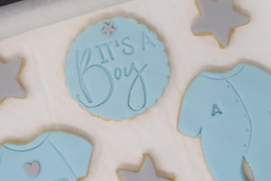 It's a boy cookie set, grey stars, blue vest and blue baby grow